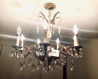 Seven arm Metal chandelier with brass accents and prisms 25”w 26” L 
$550
