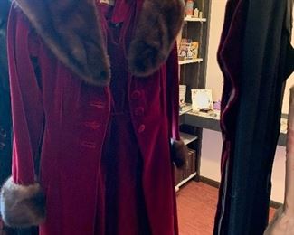 Designer coat and dress to match fur collar .