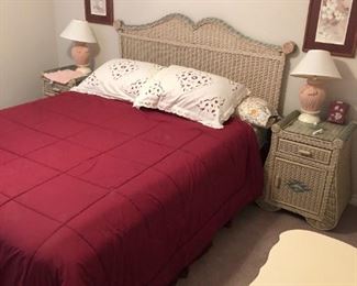 Queen bed with wicker headboard. End Tables sold.