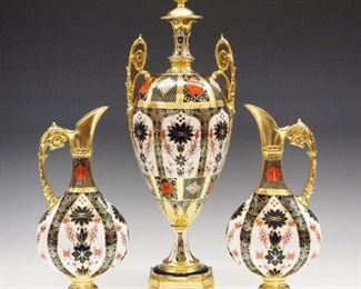 Three 20th century Royal Crown Derby "Old Imari" pattern fine bone china garniture items.   Includes an 16 1/4" two handled vase with fixed cover and two 10" single handle ewers.  Printed marks with 1128 and XXXVII and XXXVIII respectively.  Very slight wear, hairlines in the vase cover.  ESTIMATE $800-1,200
