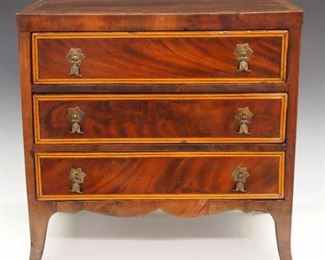 A 20th century miniature Hepplewhite style chest.  Mahogany construction with three banded drawers over a shaped apron and tall French feet.  Some wear, minor shrinkage and edge damage.  15 1/2 x 9 x 14 3/4" high.