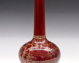 A 1920's Crown Ducal vase by E. R. Wilkes.  Bottle form with stylized floral decoration.  Faint Crown Ducal backstamp, painted artist's signature.  Minor wear, older repair to rim.  11" high. 