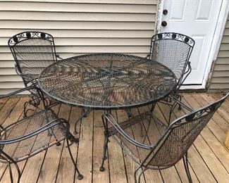Woodard round patio table and four chairs