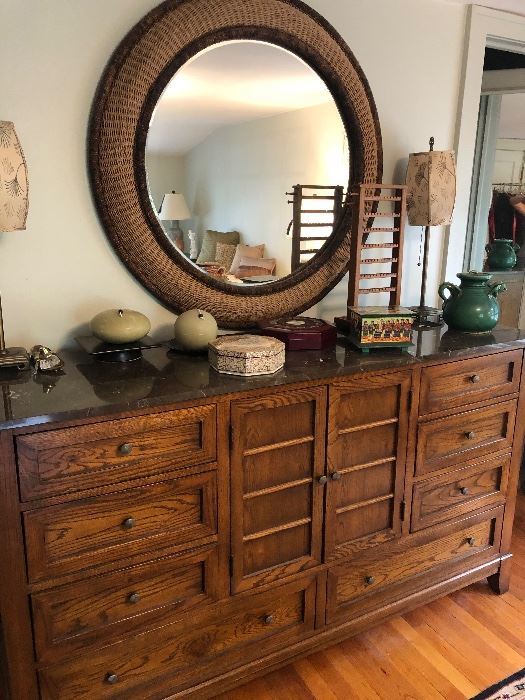 Walnut dresser with stone top and round mirror, jewelry boxes and more