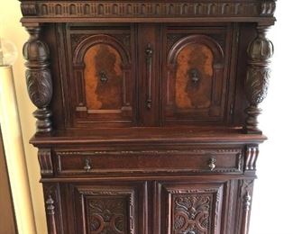 Berkey & Gay cupboard to match B & G table and sideboard shown in preceding photos.  Two upper doors with burl fronts; lower two doors have highly carved fronts.