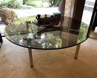 Modern glass-top coffee table with metal base/legs.