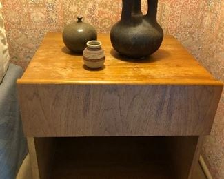 Modern nightstand; artisan pottery.