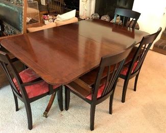 Baker dining table with four chairs.