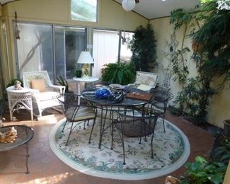 Sun room with wrought iron and wicker furniture