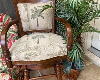 One of two palm tree fabric upholstered bar stools