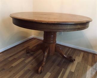 Claw foot oak dining table with two leaves