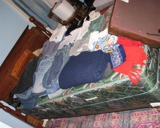 Bed with linens and a few vintage denim items