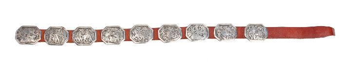 11
A Navajo Floyd Becenti Jr. "Custer's Last Stand" Silver Concho Belt
Third quarter 20th century, Navajo; Initialed to buckle
Designed with eight octagonal conchos and a buckle all depicting confrontations between Custer's US Army soldiers and American Indians, inscribed to buckle: Custer last stand July 14
51" L x 3" H; Each concho: 3" H x 3.75" W
1080.0 grams gross
Estimate: $800 - $1,200