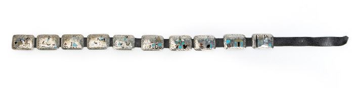 12
A Navajo Benjamin Becenti Concho Belt
Stamped: BB
The buckle and conchos designed with scenes of daily life inlaid with stones
45.25" L x 2.125" H; Buckle: 2.125" H x 3" W
Estimate: $600 - $900
