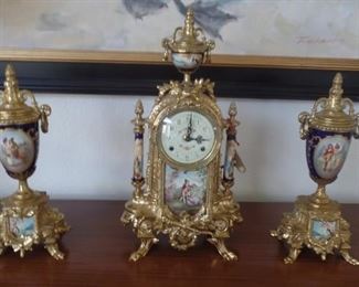 Three piece French style gold metal and porcelain clock set  $350 