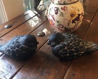 pair of stone birds next to a small English lidded jar
