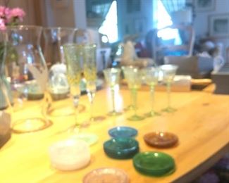 we didn't count them, but twenty-one or so colored glass butter pats.  The green glasses are paper-thin, and lovely.  We have a balled stem