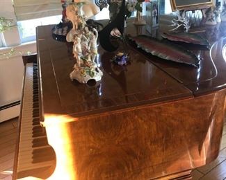 More piano with a wooden puppy resting underneath