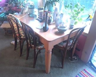 A heavy pine table with three of the bentwood chairs.  