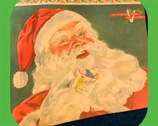 1944: “Your Chesterfield Santa Claus” offers you a cigarette jovially, while a holly-draped V reminds you to “Say it with Bonds for Victory”.  Advertising 