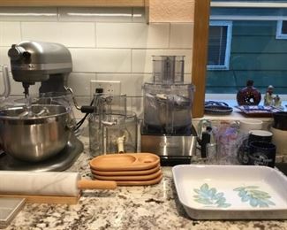 Ceramic Tray, Mugs, Measuring Cups, Cuisnart Food Processor, Kitchen Aid Mixer, Marble Rolling Pin,  Wooden Cup and Plate trays.
