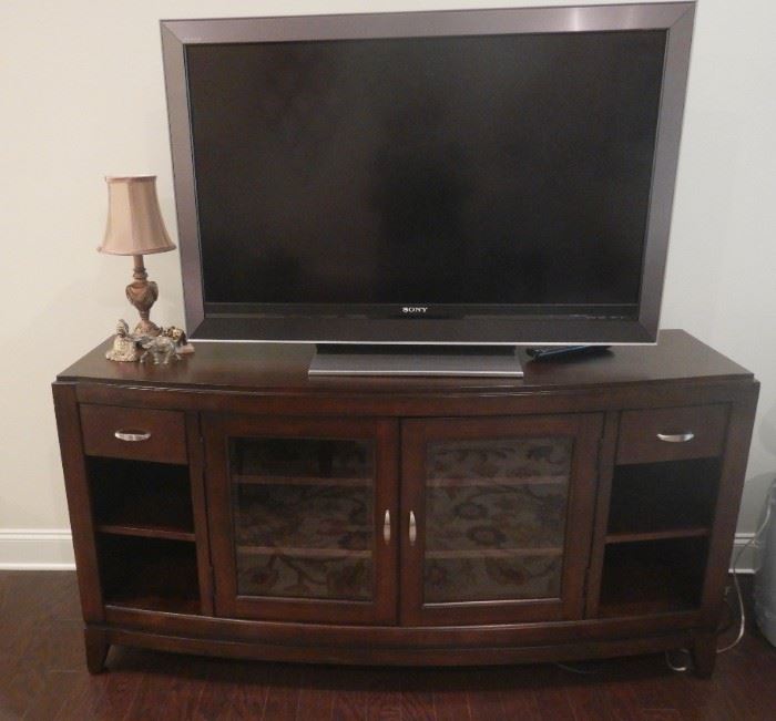 Beautiful cherry entertainment cabinet.  Glass doors, two drawers and shelving.  Excellent condition