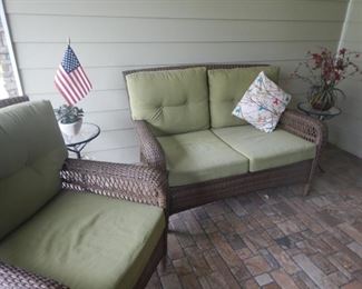 Outdoor wicker settee with cushions
