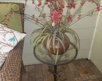bird motif metal table and floral arrangement
