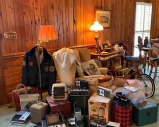 Many vintage items such as movie and slide projectors, radios, cassette tape players, cameras and equipment, pocket knives, cast iron bank, Look and Life magazines, cast iron door stops, and much more. 