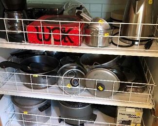 Pots pans, wok, electric hot water kettle.  Coffee pot. Correll cook and serving pieces.  