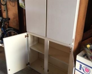 Two separate, 2-door white cabinets. Can be stacked together as shown or side-by-side or individually. Being sold together or separately. 