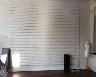 Lot faux brick slat wall in room