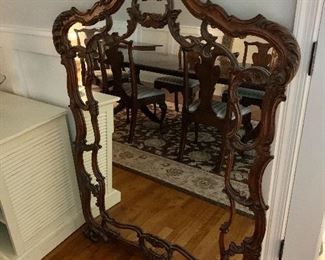 $395 - Ornate wood mirror. Has a repaired crack in the wooden top crest. 56"H x 39"W.