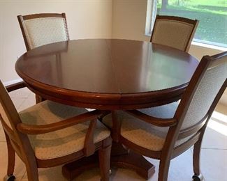Simple and elegant Thomasville round dining set with 4 rolling chairs and one leaf.