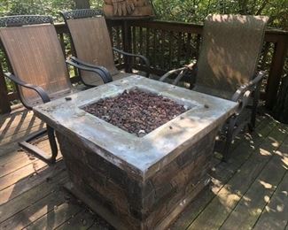 another set of patio chairs and a fireplace for outdoors