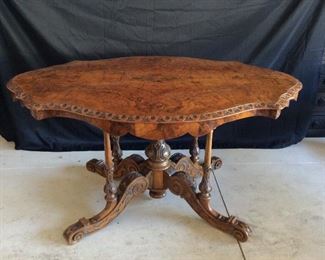 Italian hand carved table in walnut and briar wood, scalloped apron, carved pedestal and carved supports, c. 1860