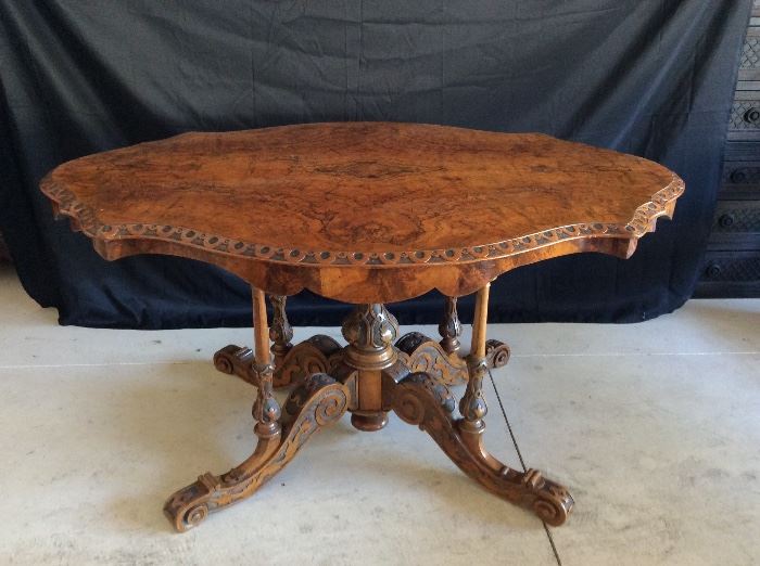 Italian hand carved table in walnut and briar wood, scalloped apron, carved pedestal and carved supports, c. 1860