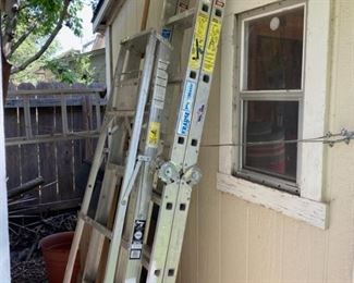 Three aluminum ladders