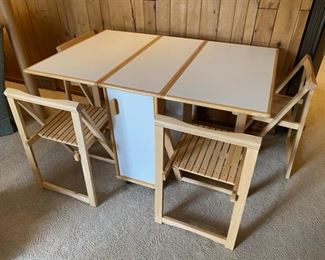 Cool vintage drop leaf table with four self storing wood folding chairs, perfect for at-home learning!