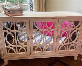 This mirror front media console cabinet can be altered by removing or replacing the mirrors for an alternate background! A truly versatile piece 