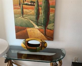 Rattan sofa/foyer table with coordinating artwork and decor