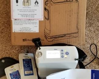 Inogen One G4 portable oxygen concentrator with 3 batteries and case. Appears fully operational.