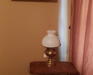 gold shelf, small table, lamp