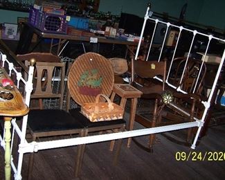 Other side of cast iron bed with folding chairs and rocker