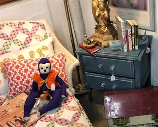 Old doll house, wicker chaise and painted side table.  
