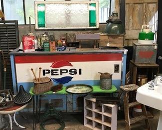 Stained glass window and old Pepsi cooler. 