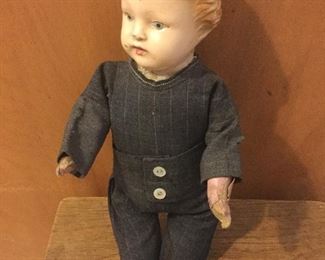 Tin head boy doll.  Composition hands.  Cloth body.  Linsey woolsey suit. 