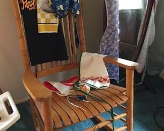 Wooden rocker with vintage aprons.