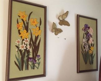 Framed crewel floral scenes.
