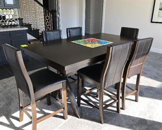 #20)  $500 - Solid Wood Counter Height Game Table with 6 Leather Barstool height chairs.  (Some damage to one leg)  72w x 40d x 36h.  This item may not be picked up until Wednesday, Oct 14 between 3:00 and 7:00 p.m.